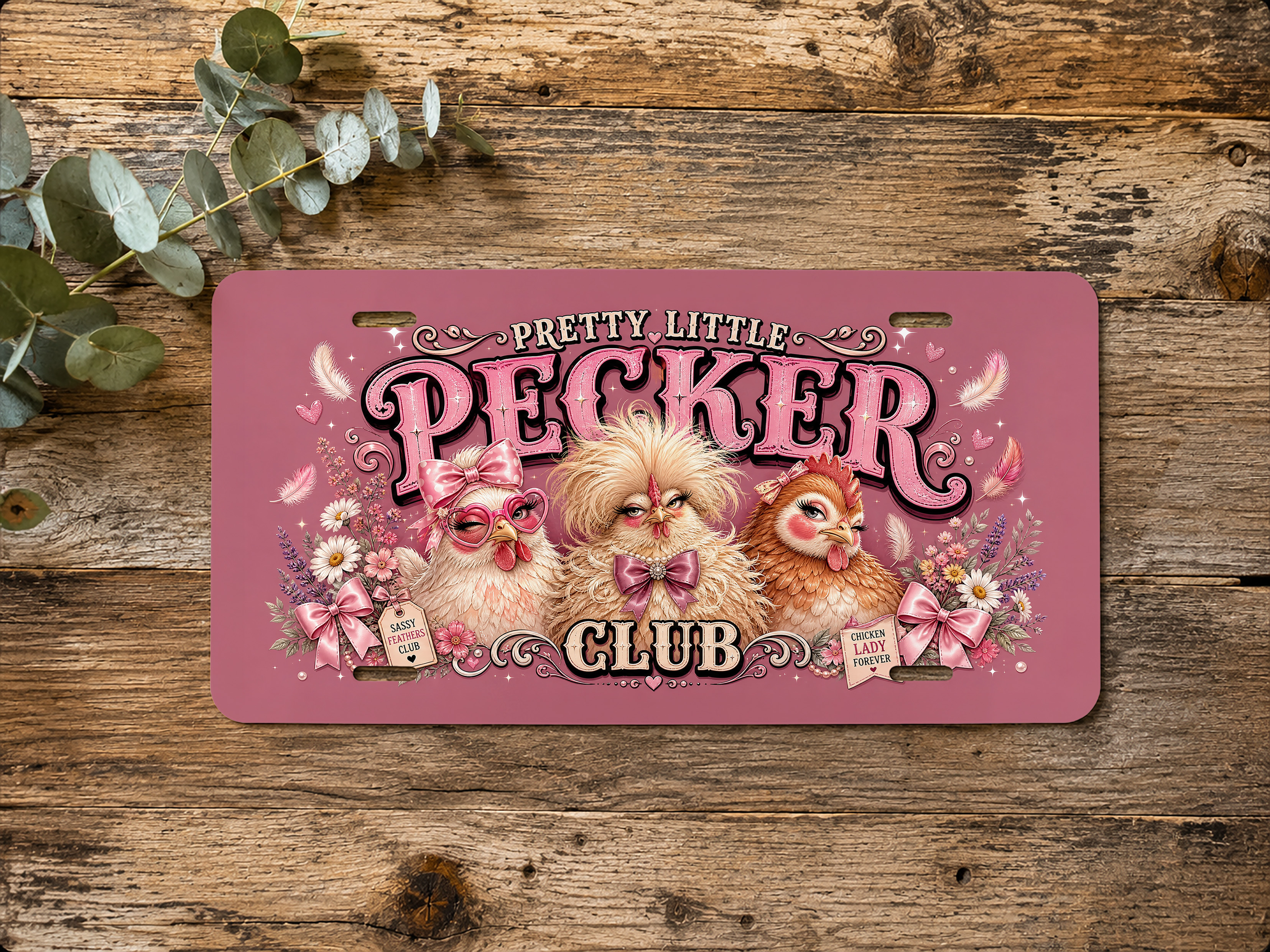 Featured view of the funny chicken vanity plate with three stylized chickens and decorative floral bow details.