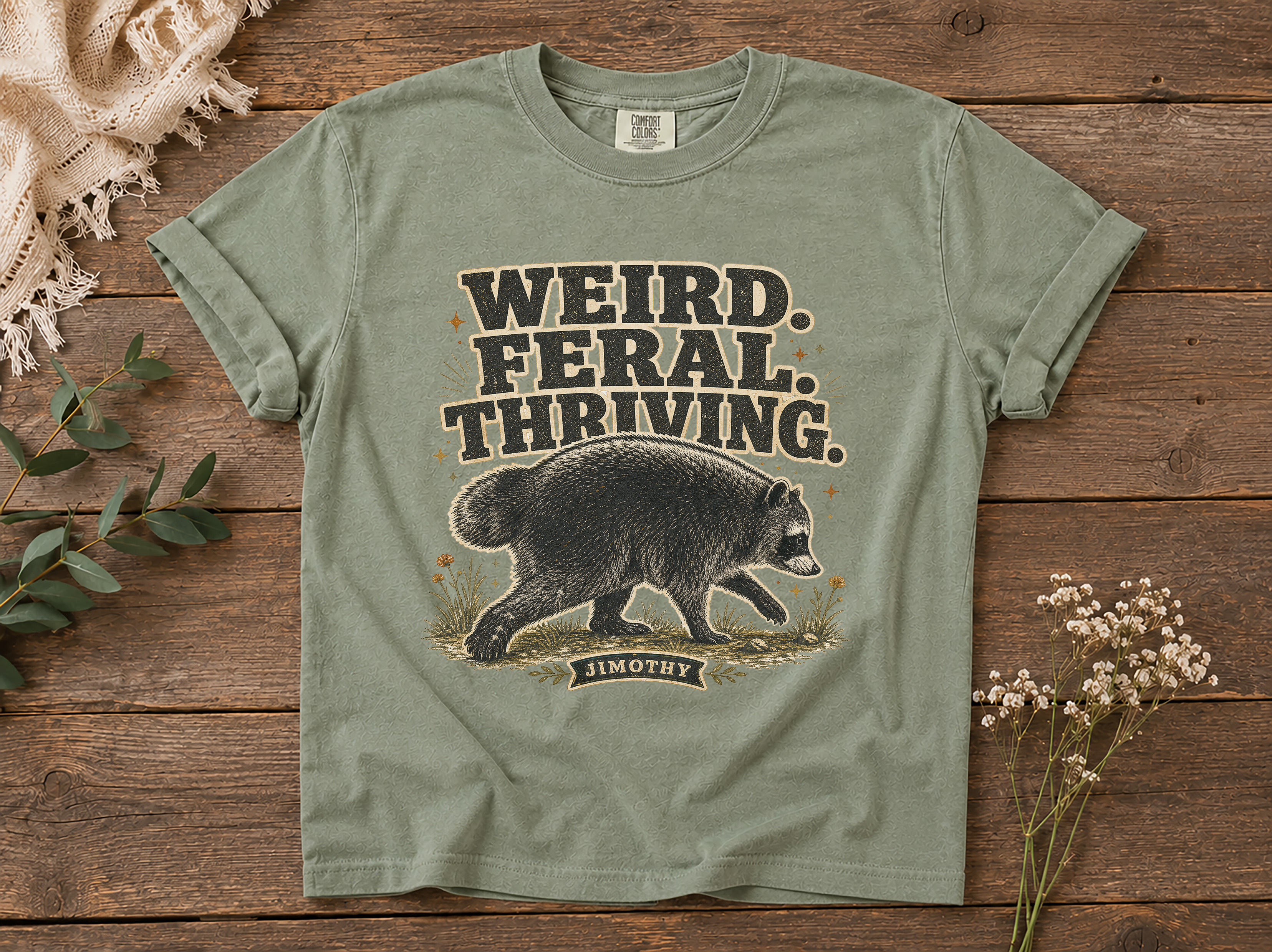Featured mockup of a weird feral thriving raccoon shirt on a wooden-plank backdrop.