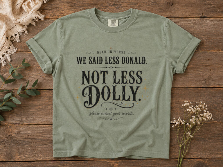 Featured Moss garment-dyed tee with black and gold-toned vintage western lettering for a Dear Universe Dolly shirt.